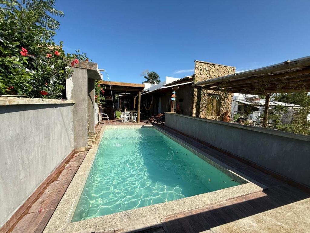 a swimming pool in the backyard of a house at Casa de Pedras in Prado