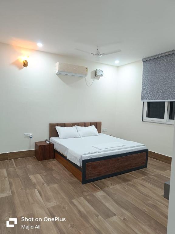 a bedroom with a bed in a room at Rocopie farm in Rohtak