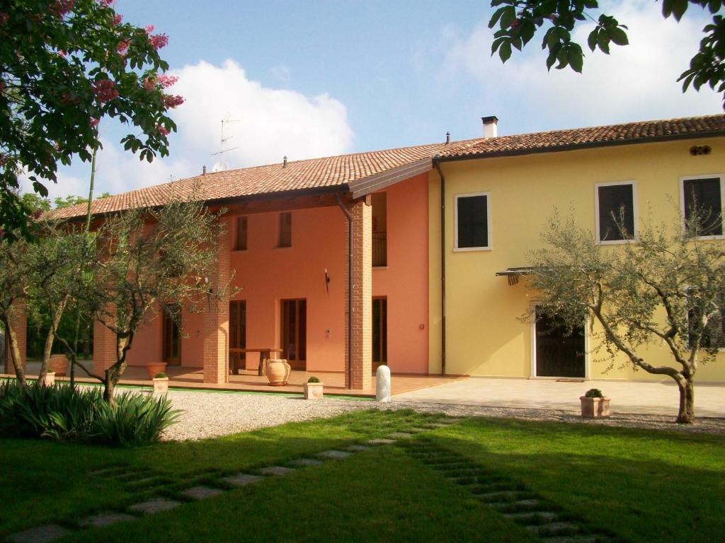 una casa naranja y amarilla con patio en Agriturismo Radaméz, en Monzambano