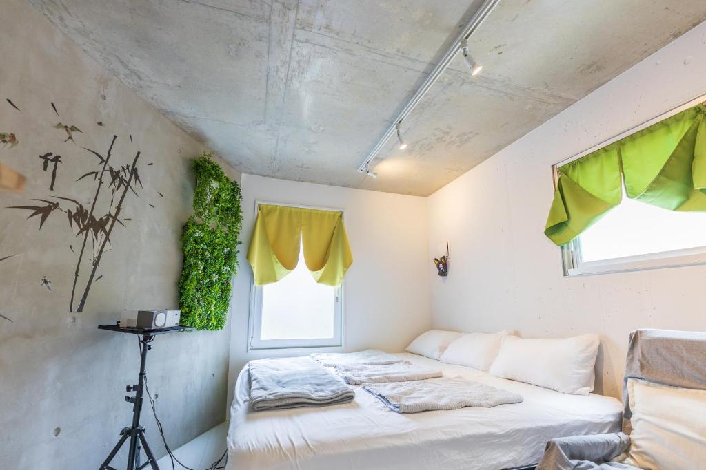 a bedroom with two beds in a room with a window at Fox & Fortune 4A -Renovation in Jan 3min to Station Nomad Stay- in Tokyo