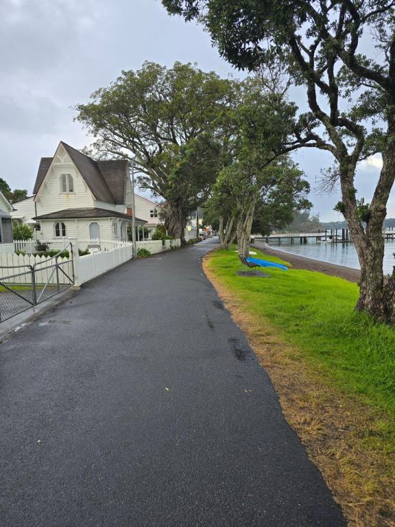 a road next to a house next to a body of water at 47 The Strand Apartment ground level in Russell