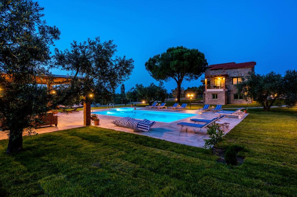 a swimming pool in the backyard of a house at Mediterraneo Luxury Suites Halkidiki in Vourvourou