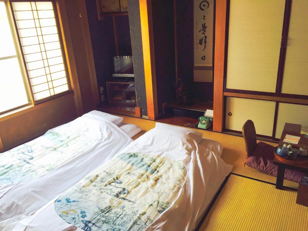 Postel nebo postele na pokoji v ubytování Ryokan Kaminaka