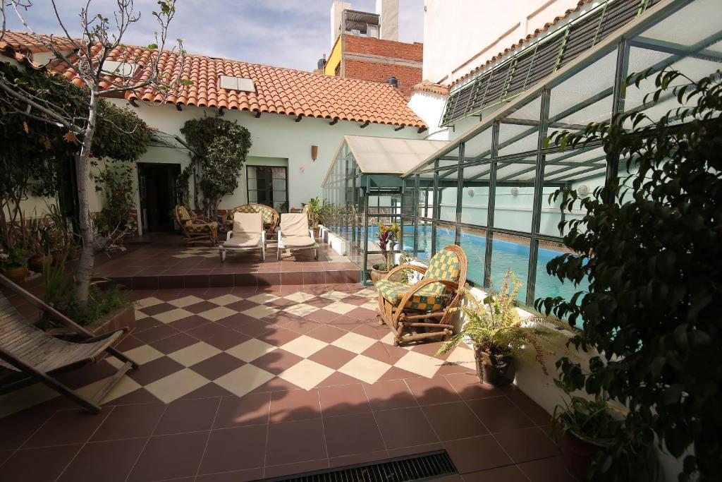 an outdoor patio with chairs and a swimming pool at Casa Verde B&B in Sucre