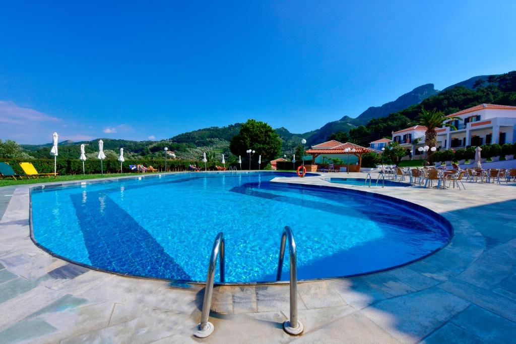 a large blue swimming pool in a resort at Arion Hotel in Kokkari