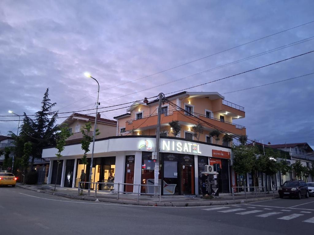 a nissen store on the corner of a street at Italian style Apartment in Durrës