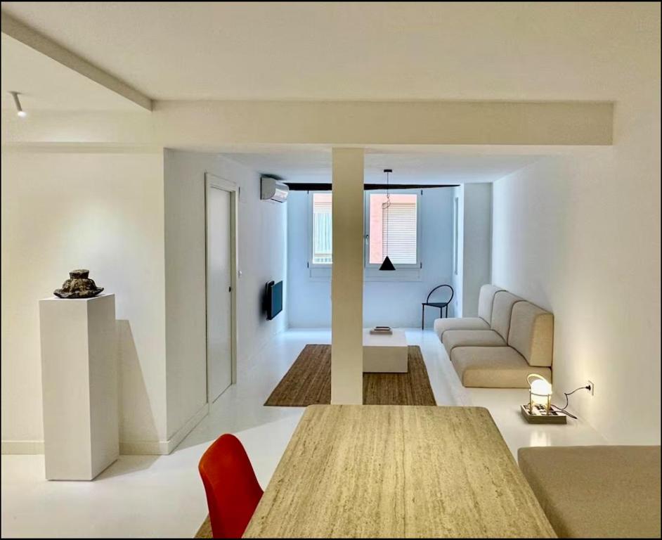 a living room with a table and a couch at Urdaibaibai Desing in Bermeo