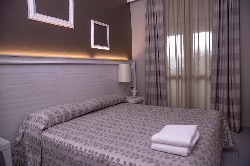 Postel nebo postele na pokoji v ubytování Hotel Degli Ulivi
