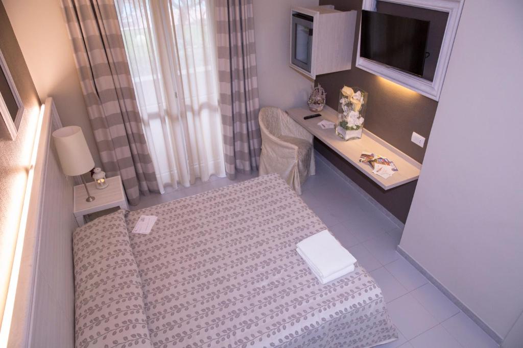 Postel nebo postele na pokoji v ubytování Hotel Degli Ulivi
