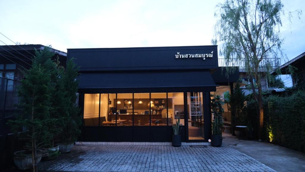桑卡武里บ้านสวนสมบูรณ์的黑色遮阳篷的商店前部