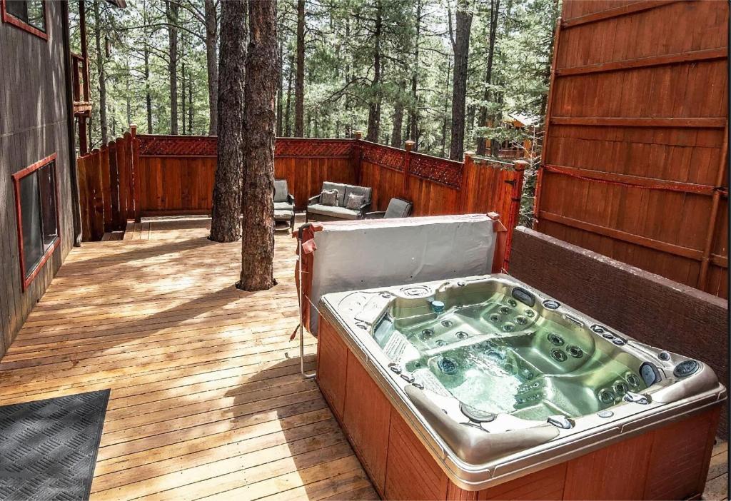 a hot tub on the deck of a house at Eternal Treehouse Hot Tub Outdoor Oasis in Pines Entertainment Galore in Mountainaire