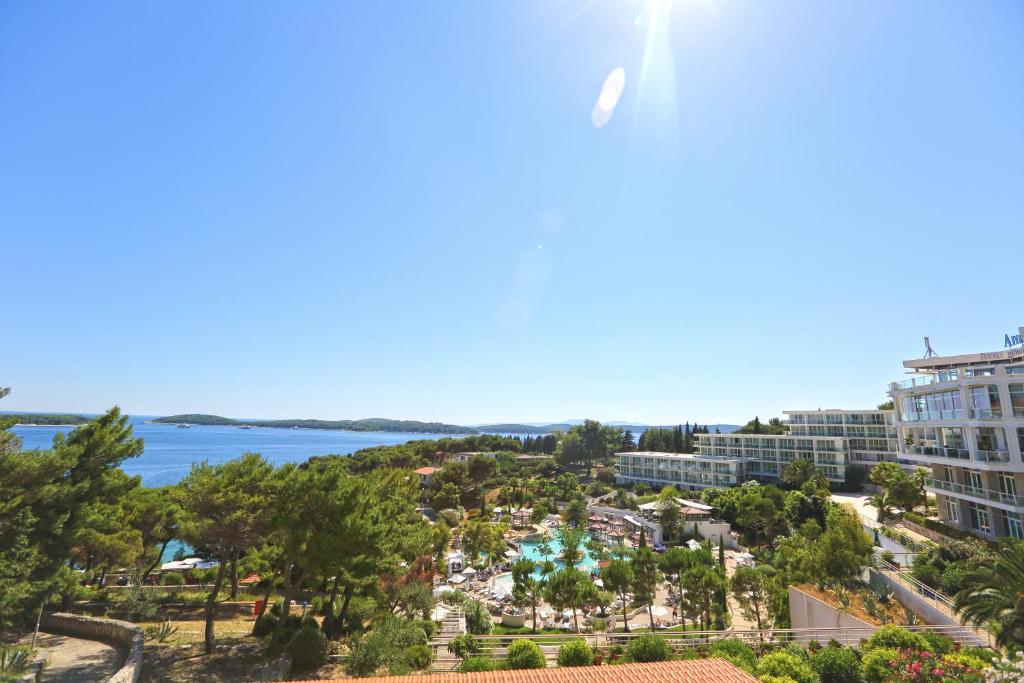 a view of a resort with the ocean in the background at Apartments Villa Dinka in Hvar