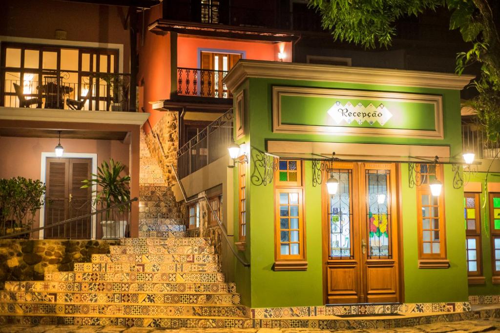 a building with stairs in front of it at night at Pousada Perequê in Ilhabela