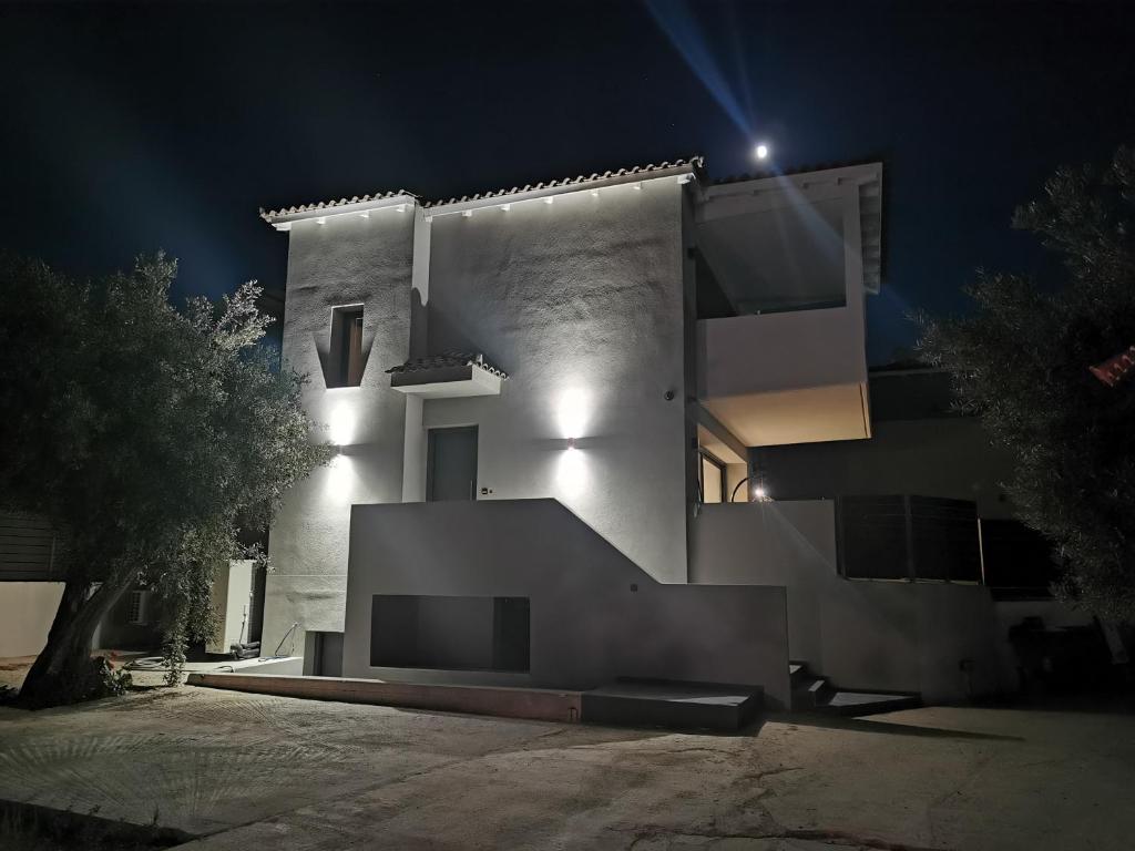 a white building at night with lights on it at Breeze Concept Villa in Drosia