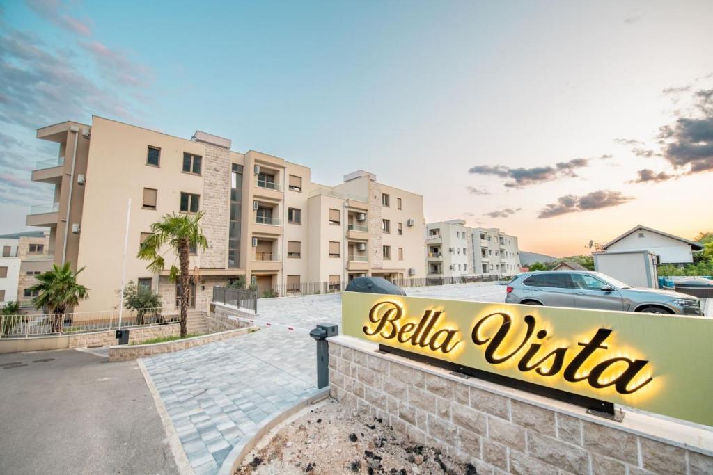 a sign in a parking lot with buildings in the background at Bella Vista Pleasure in Baošići