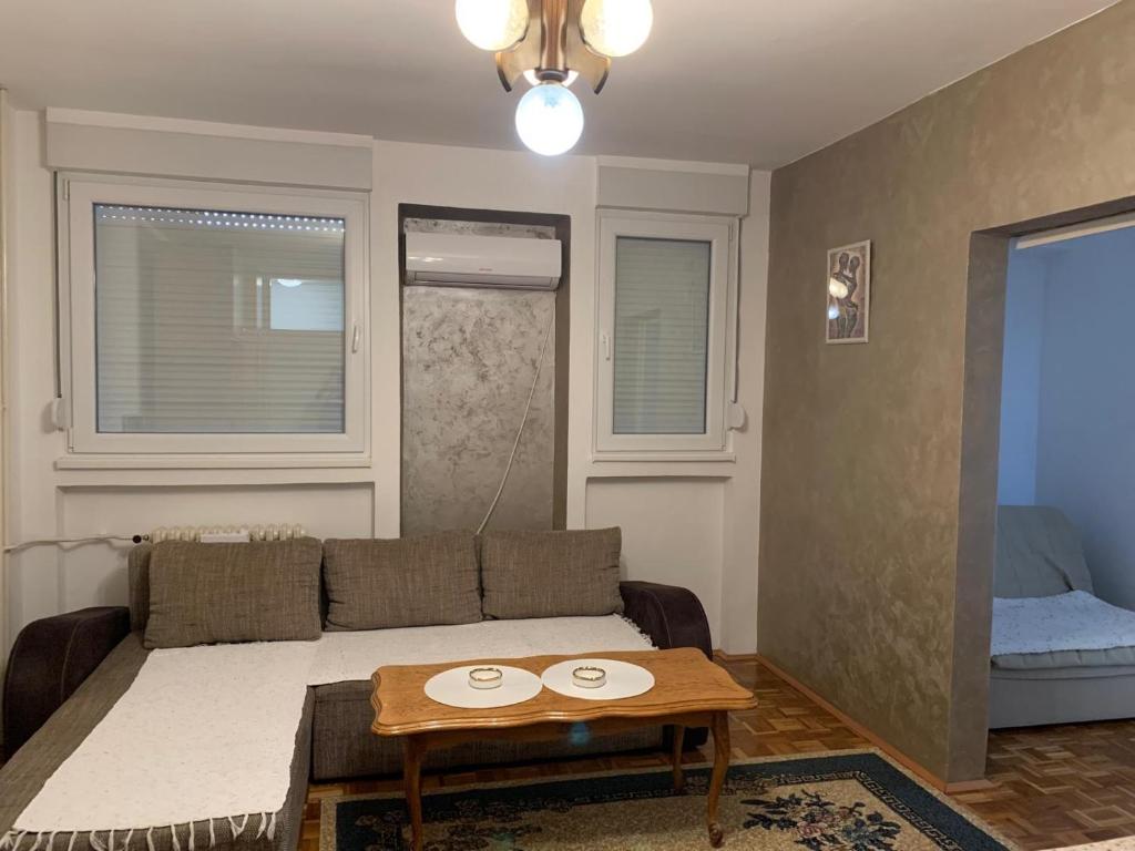 una sala de estar con un sofá y una mesa en Stan na dan kod Rode, en Šabac