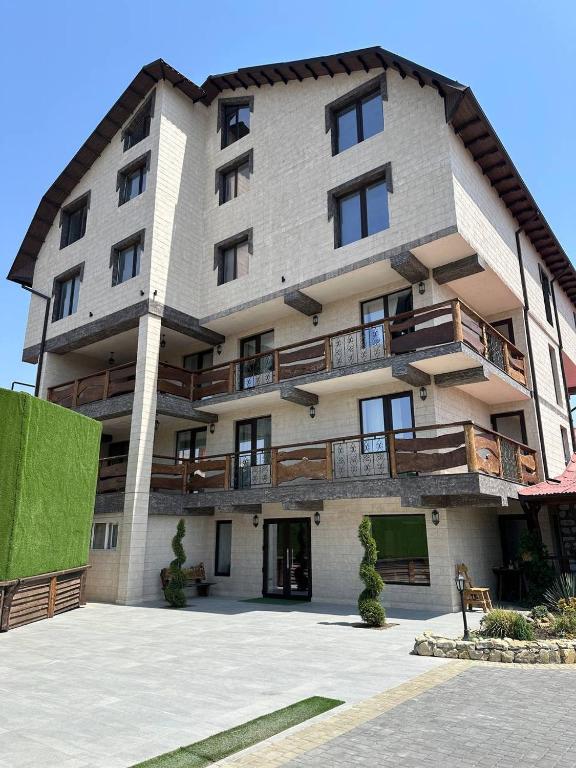 a large building with balconies on the side of it at Hotel Racu Family in Komrat