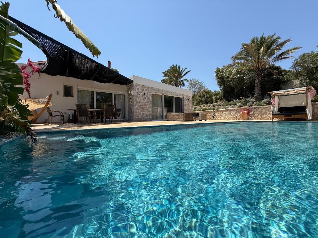 a large swimming pool in front of a house at Villa Splendide in Rhodes Town
