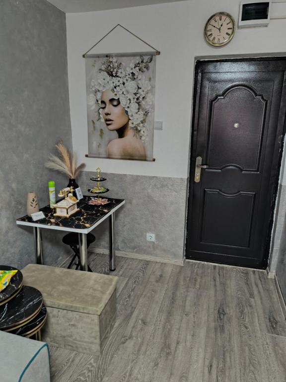 a room with a table and a black door at Home MARIA in Orşova