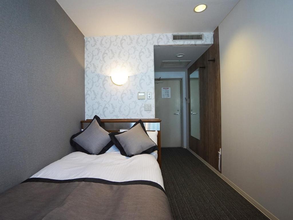 Postel nebo postele na pokoji v ubytování Hotel Areaone Kochi
