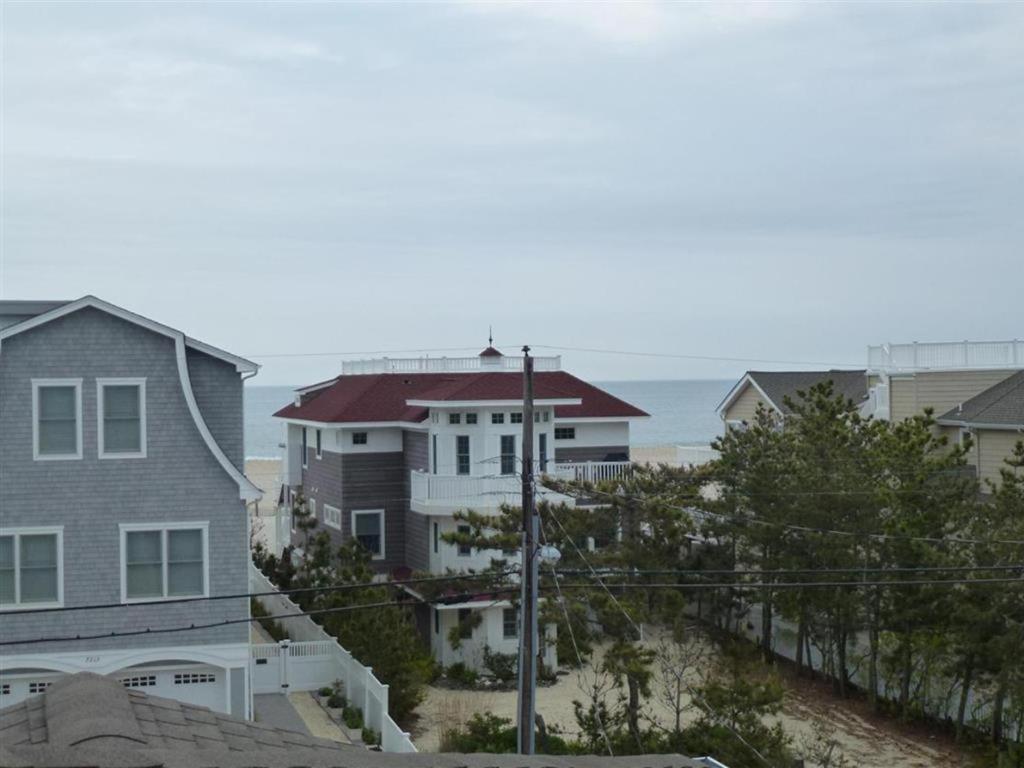 a group of houses with the ocean in the background at Oceanside Brant Beach Single Family Beach Badges Private Yard Wifi Ocean And Bay Views Washer & Dryer This Home Will Allow You To Truly Feel in Brant Beach