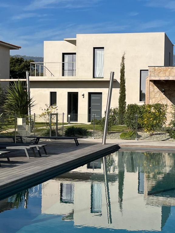 a house with a swimming pool in front of a house at Villa U Sanda in Lecci