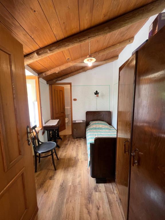 a bedroom with a bed and a table and a chair at Rooms Poli Luce - Room Zvane in Gračišće