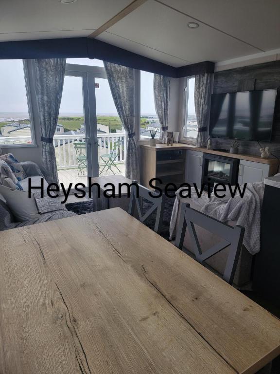 a dining room with a table and a view of the ocean at Heysham seaview in Heysham