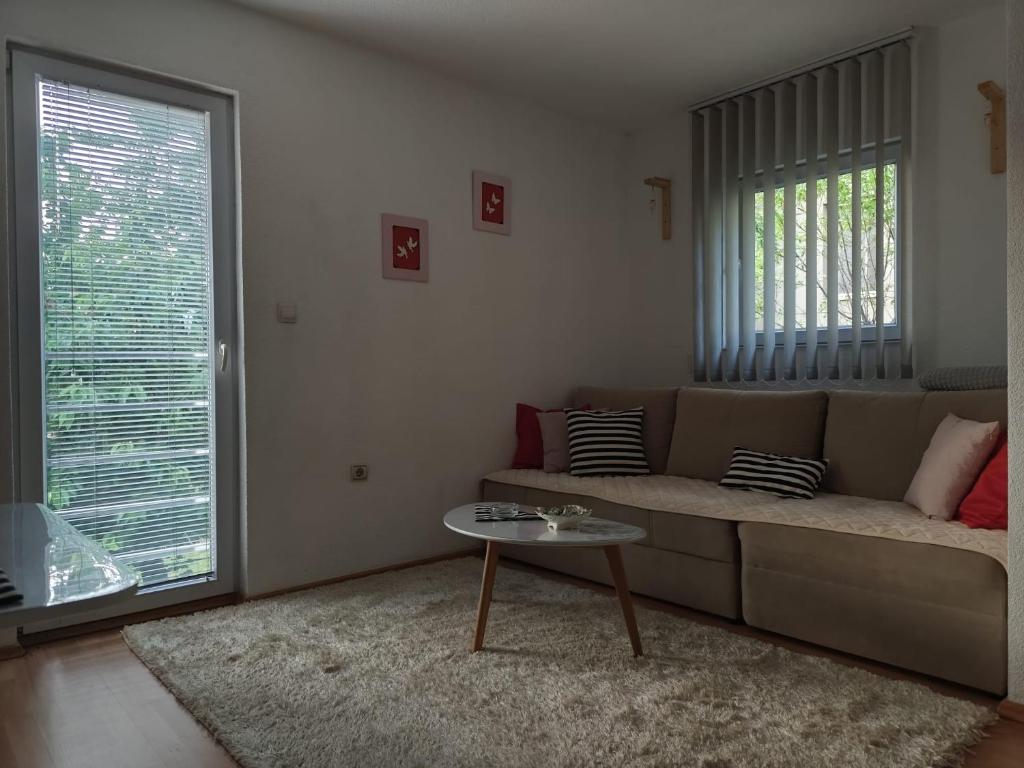 a living room with a couch and a table at Apartment Lilac Sarajevo in Sarajevo