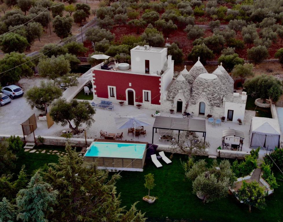 an aerial view of a house with a swimming pool at Lamarossa Trulli & Suites in Monopoli