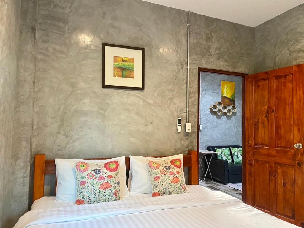 une chambre avec un lit avec deux oreillers dans l'établissement Longhaad Lanta garden resort, à Ban Ai Dao