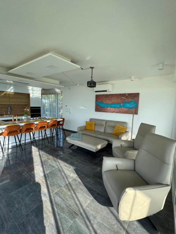 a living room with a couch and a table at Villapark apartman A-B 12 in Fonyód