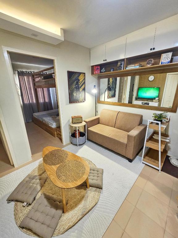 a living room with a couch and a table at Vito Condotel in Piapi