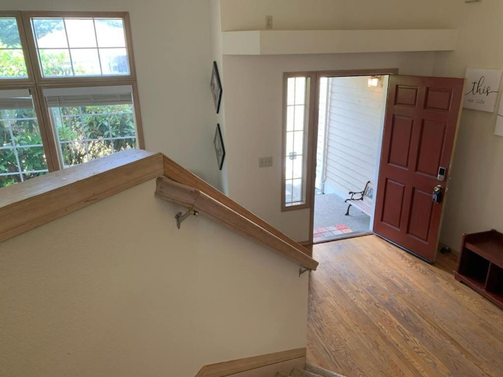 an empty room with a staircase and a red door at Cedar River one bedroom in a four bedroom house in Renton