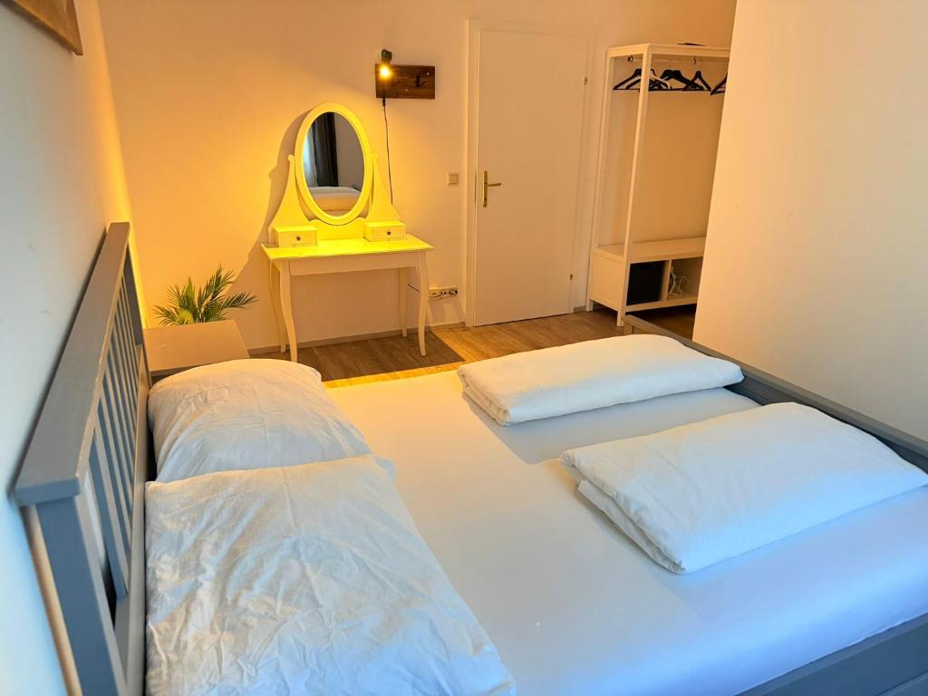 a room with two beds and a yellow mirror at Gesamte Unterkunft für 4 Top 18 in Vienna