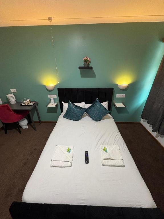 a bedroom with a large white bed with two pillows at Stay Inn Express, Cambridge in Cambridge