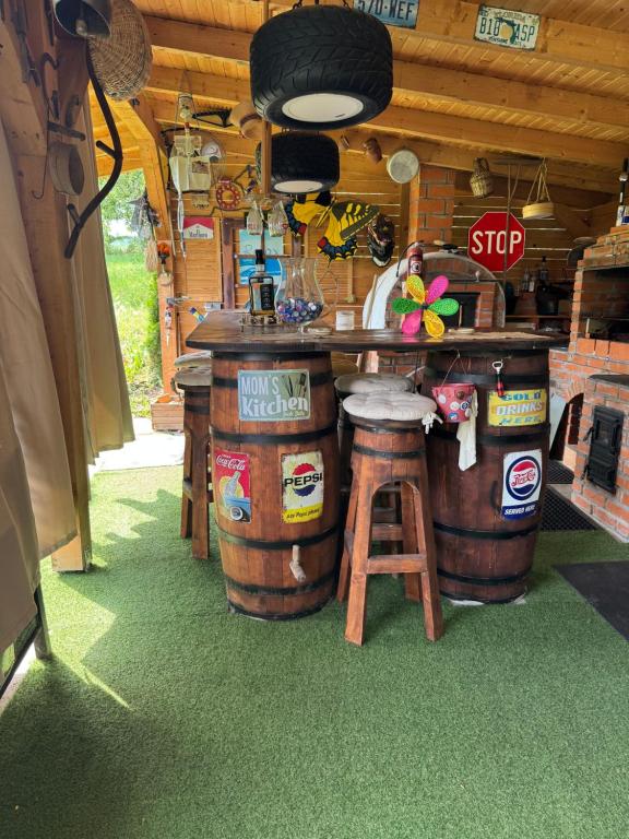 a kitchen with a counter and two large barrels at Casuta lu Carmen in Săbed