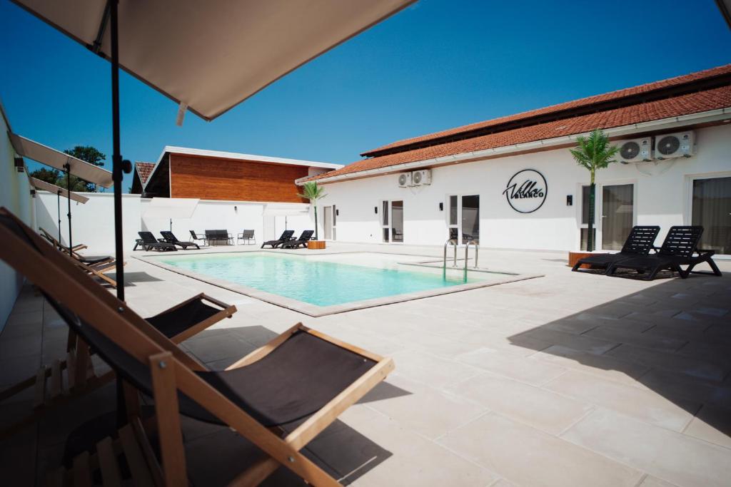 a swimming pool in the middle of a patio at Villa Apartments Blanco - Near Airport Banja Luka in Laktaši