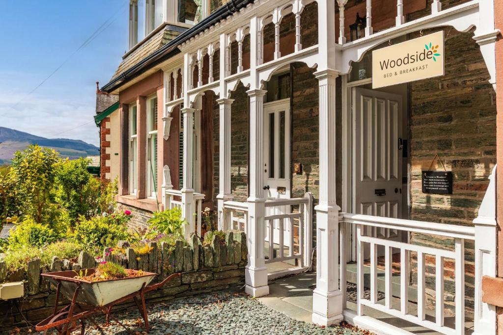 a house with a sign on the front of it at Woodside B & B in Keswick