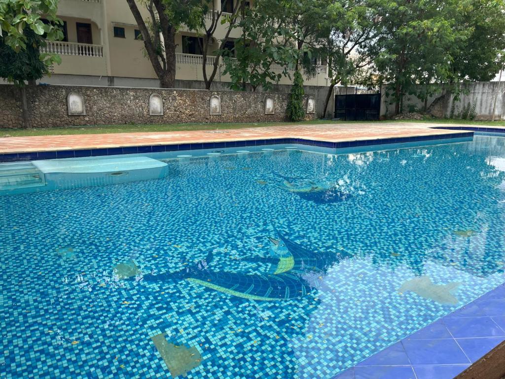 a swimming pool filled with blue water at Mambo Sea view 3bd Penthouse Mombasa in Mombasa