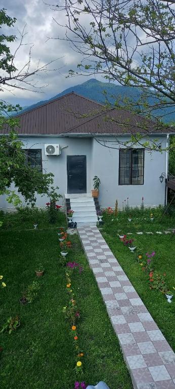 a house with a walkway in front of a yard at Samall new villa FRHD in Gabala
