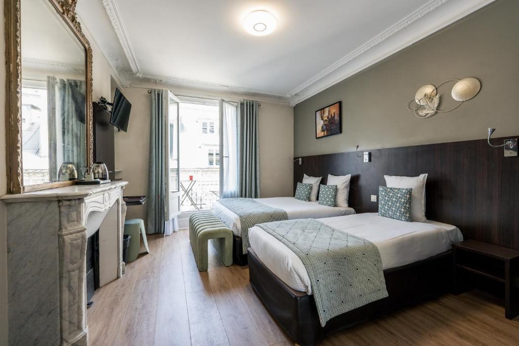 a hotel room with two beds and a fireplace at Hotel Corona -Rodier- in Paris