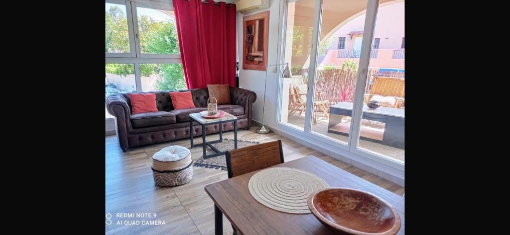 a living room with a couch and a table at Studio à Port Grimaud in Grimaud