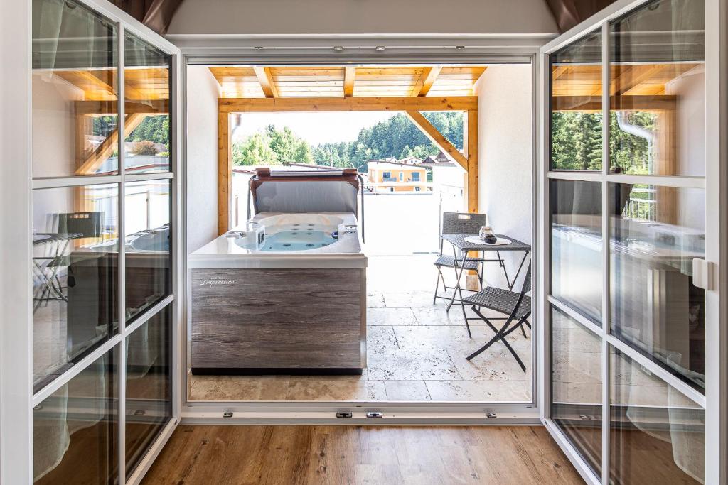 a room with a tub inside of a house at Ferienbahnhof Fichtental Bahnhofs-Loft in Prackenbach