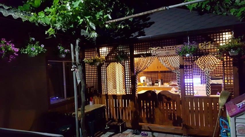 a gazebo with a bar in it at night at Casa Stefania in Eforie Nord