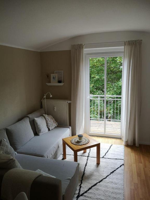a living room with a couch and a table and a window at Wohnung Chemnitz-Zentrum in Chemnitz