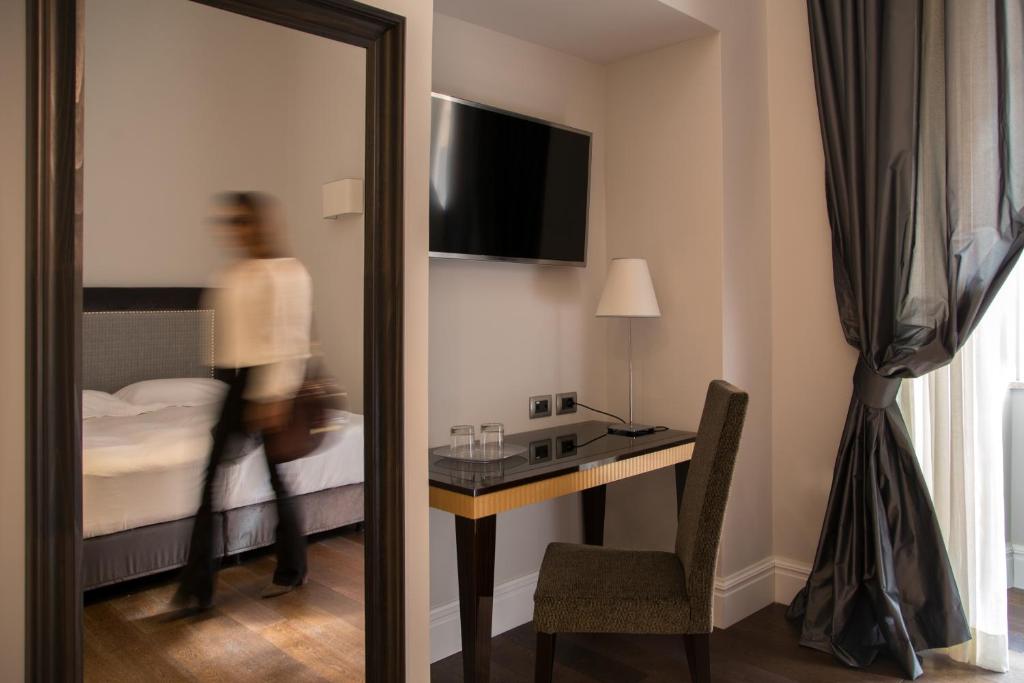 Posteľ alebo postele v izbe v ubytovaní Tridente Suites