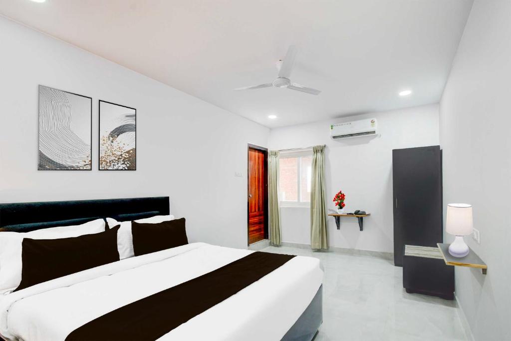 a white bedroom with a black and white bed at Collection O Collection O BN Reddy Formerly Capitol Stay inn in Maula Ali