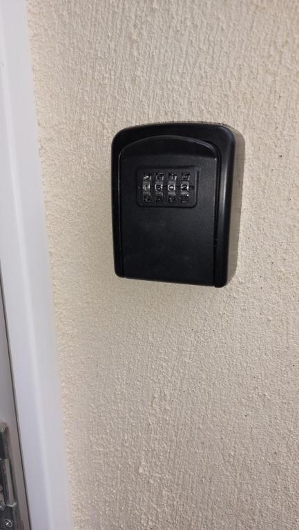 a black button on the side of a wall at cocon des arènes et parking in Nîmes