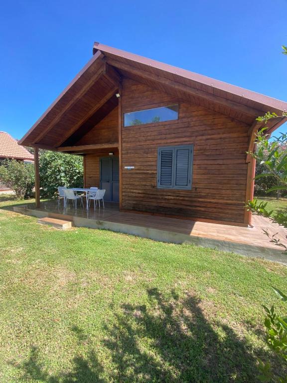 a house with a table and chairs in a yard at Bungalow tra natura e mare in Capo Colonna